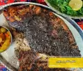 طرز تهیه ماهی شکم پر جنوبی با تمر هندی و رب انار در فر گام به گام